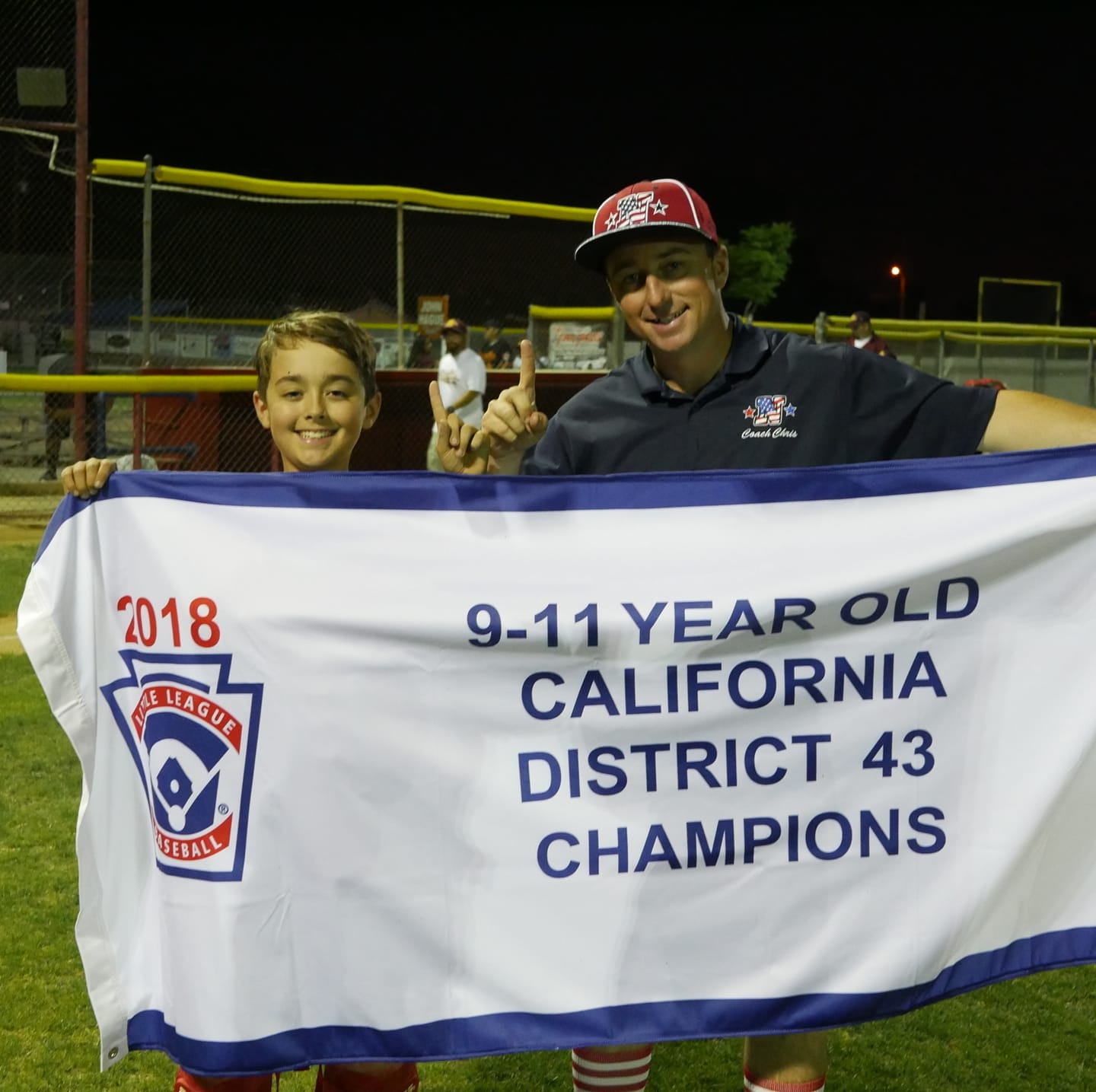 Picture of Coach Chris holding banner with player